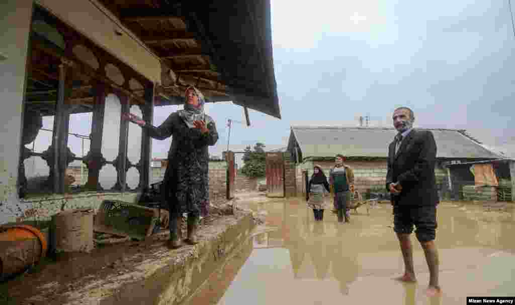 Residents of northern Iran show their flood-damaged home.&nbsp;