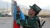 An Azerbaijani serviceman hoists the flag during a ceremony at a border outpost opened in the village of Mincivan, Zangilan District.