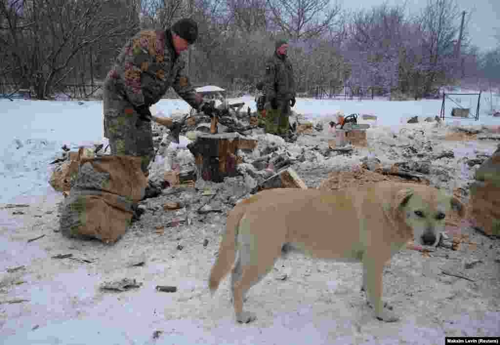 A Ukrainian soldier chops firewood on the front line near the village of Pisky in the Donetsk region on January 29.