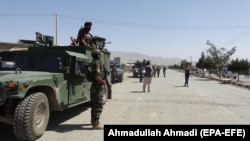 Afghan security officials secure the roads leading to the scene of suicide bomb blasts that killed dozens in the provincial capital of Gardez in Paktia Province on August 3. 