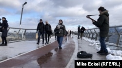 Overlooking the Dniepr River, and stretching between St. Volodymyr Hill and the People's Friendship Arch, the 3-year-old Glass Bridge is a popular destination for tourists and buskers.