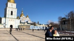 A newly married couple poses for photographs in front of Kyiv’s St. Michael Cathedral on February 12. Despite the looming threat of a new war, life has continued uninterrupted in the Ukrainian capital.