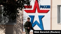 A Russian serviceman walks past the Operational Group of Russian Forces headquarters in Tiraspol, where Moscow maintains some 1,400 troops.