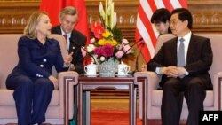 U.S. Secretary of State Hillary Clinton (left) speaks with China's President Hu Jintao during a meeting at the Great Hall of the People in Beijing on May 4.