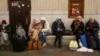 People gather at a subway station in Kyiv on February 24 as they seek shelter from expected Russian air strikes. 