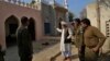 A mosque custodian briefs police officers about the mob lynching attack on Muhammad Mushtaq in Khanewal, eastern Pakistan.