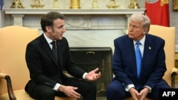 U.S. President Donald Trump (right) meets with French President Emmanuel Macron at the White House on February 24.