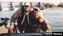 Abdul-Rahman (Peter) Kassig (right) fishes with his father, Ed Kassig, near the Cannelton Dam on the Ohio River in southern Indiana in 2011.