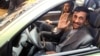 Iranian President Mahmud Ahmadinejad waves to the press as he sits in a car during an inaugural ceremony for Saipa group's All-Iranian Automobile production line, Miniator, in Tehran in December 2008.