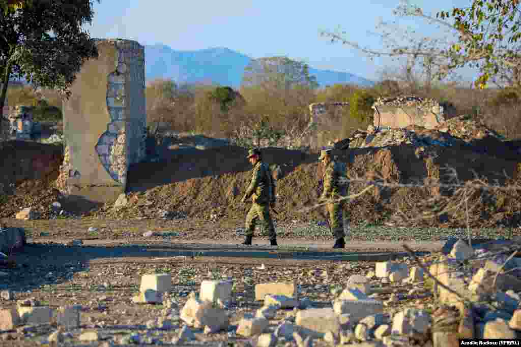 On patrol: Azerbaijani troops amid ruined buildings in Agdam.