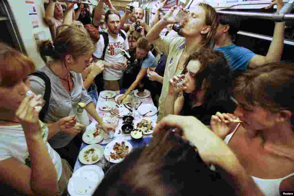 Nadezhda Tolokonnikova (bottom right) and fellow activists celebrate a wake for conceptual artist Dmitry Prigov in a Moscow metro carriage in August 2007. Tolokonnikova later became a member of Pussy Riot.