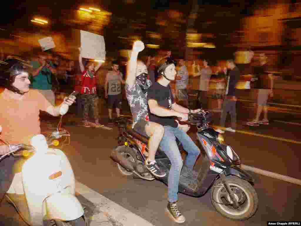 A group of young protesters on scooters during the short march.&nbsp;