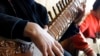 In this photo from 2013, an Afghan girl practices playing the sitar in a class at the Afghanistan National Institute of Music (ANIM) in Kabul.