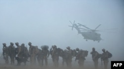 U.S. marines await helicopter transport as part of Operation Khanjar in Helmand Province on June 2.