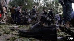 A victim's shoe lies on the ground as police secure the site of a suicide attack in Kabul in June.