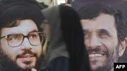 Portraits of Hezbollah Secretary-General Sheikh Hassan Nasrallah (left) and Iranian President Mahmud Ahmadinejad at an annual Koran exhibition in Tehran in 2007.