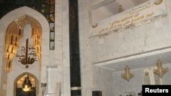 Security personnel inspect the site of a bomb attack inside the Umm al-Qura mosque in Baghdad.