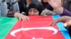 A woman cries at the coffin of an Azerbaijani soldier killed in fighting over the breakaway Nagorno-Karabakh region at a funeral ceremony in the Beylagan district on September 30.