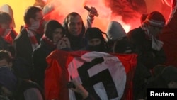 Spartak Moscow fans hold a Nazi flag during a match pitting their club against Shinnik Yaroslavl on October 30, 2013.