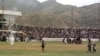 Taliban fighters and thousands of residents of the Afghan capital, Kabul, watch as surgeons cut off a thief's hand in the national stadium on August 7, 1998.