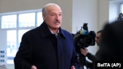 Belarusian President Alyaksandr Lukashenka speaks to journalists as he visits the paper factory in Dobrush on February 4.