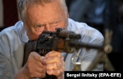 Vladimir Zhirinovsky checks out a Kalashnikov PK rifle during his visit to the shooting range of the Volunteer Society for Cooperation with the Army, Aviation, and Navy organization in Moscow in August 2021.