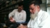 Haji Rasheed (right) bags a book for a customer in front of the dwindling stock of books at his Maktaba-e Sarhad bookstore in Peshawar.