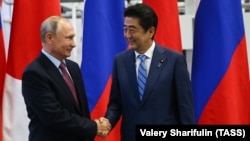 Russian President Vladimir Putin (left) meets with Japanese Prime Minister Shunzo Abe in Vladivostok on September 10. 