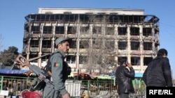 Afghan policemen in front of the Kabul shopping mall where Taliban gunmen battled security forces for hours on January 18.