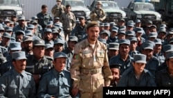 Afghan General Abdul Raziq (center), police chief of Kandahar, poses for a picture during a graduation ceremony at a police training center in Kandahar in February 2017.