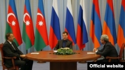 Russian President Dmitry Medvedev flanked by the presidents of Azerbaijan and Armenia -- Ilham Aliyev on the left and Serzh Sarkisian on the right -- at a previous tripartite meeting