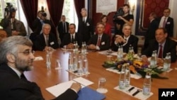 Iran's Said Jalili (left) across the table in Geneva from U.S. Under Secretary of State Burns (seated, third from right) and Javier Solana (seated, right)