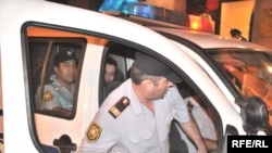 The two activists being arrested early on July 9.