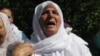 Hatidza Mehmedovic prays near the graves of her two sons and husband at the Memorial Center in Potocari, near Srebrenica, on November 14, 2017.