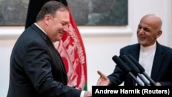 Afghan President Ashraf Ghani (right) and Secretary of State Mike Pompeo shake hands following a news conference at the Presidential Palace in Kabul in July.