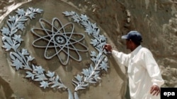 A worker in Islamabad cleans a bas-relief of the Chaghi Mountains, where Pakistan conducted its atomic explosions in 1998.