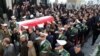 An Iranian honor guard carries the coffin of a former ambassador to Lebanon, Ghazanfar Roknabadi, who was killed during the hajj in Saudi Arabia in a repatriation ceremony upon the arrival of his body at Tehran's Mehrabad Airport on November 27, 2015. 