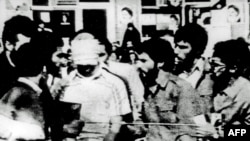 A blindfolded U.S. hostage is paraded by his captors at the compound of the U.S. Embassy in Tehran in November 1979.