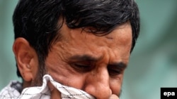 Iranian President Mahmud Ahmadinejad cries as he attends a mourning ceremony in Tehran in May 2009.