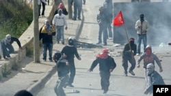 Palestinian youths confront Israeli soldiers during clashes in East Jerusalem on March 16.