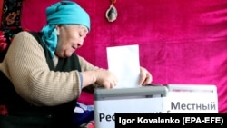 A woman casts her vote in the constitutional referendum in the village of Besh-Kungei, near Bishkek.