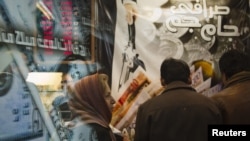 A woman stands in a currency exchange shop in northern Tehran on January 3.