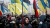 People attend a rally in front of the Ukrainian parliament on January 16, calling for lawmakers to recognize Russia as an aggressor state and implement other legislative changes concerning the occupied parts of eastern Ukraine. 