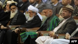 President Hamid Karzai (second from right) attends a Loya Jjirga gathering of tribal and political leaders in 2011.