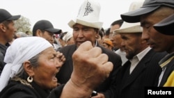 A supporter of President Kurmanbek Bakiev (left) argues with interim government followers attempting to hold a rally at the central square in Jalal-Abad on April 14.