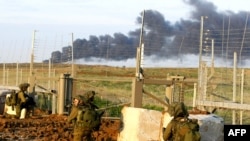 Israeli soldiers cross the border into the Gaza Strip.