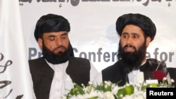 Muhammad Naeem (right), a spokesman for the Office of the Taliban of Afghanistan, speaks during the opening of the Taliban Afghanistan Political Office in Doha, Qatar, on June 18.