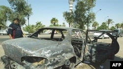 A burned-out car on the site where Blackwater guards who were escorting U.S. Embassy officials opened fire in the western Baghdad neighborhood of Yarmukh in September 2007.