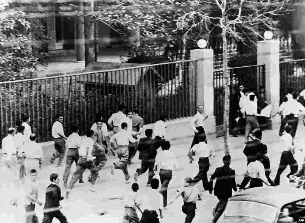 Protesters run in the streets of Tehran.