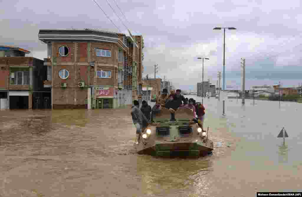 Military vehicles arrive to rescue people during floods in the northern city of Aq Qala in Golestan Province.